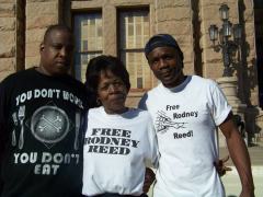 Rodney's mother, Sandra Reed, stands with one of Rodney's brothers and a cousin in front of the Texas State Capitol Building