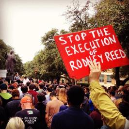 Supporter holds a sign reading "Stop the Execution of Rodney Reed" in a crowd gathered around the Martin Luther King, Jr statue at the University of Texas at Austin. Picture by Hooman Hedayati
