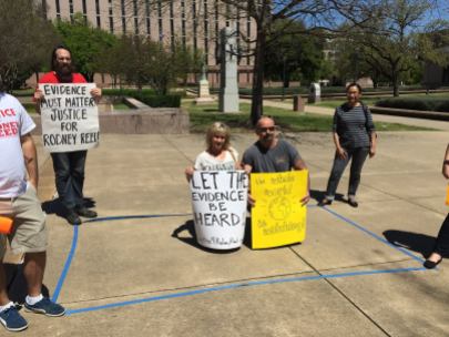 Outside the Court of Criminal Appeals, supporters kneel inside a 6' x 10' area representing the size of cells on Texas death row
